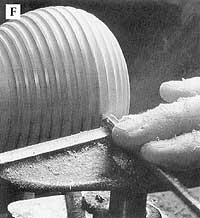 Follow the evenly spaced lines marked on the body to cut the coves with a spindle gouge.
