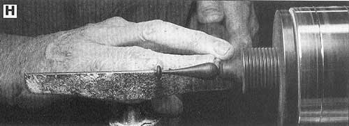 Refine the shape of the ebony handle with a spindle or roughing gouge.